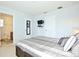 Bedroom featuring neutral décor, TV, and ensuite bathroom at 2660 Santosh Cv, Kissimmee, FL 34746