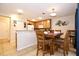 Cozy dining area features a wooden table set for four, adjacent to the kitchen at 2660 Santosh Cv, Kissimmee, FL 34746