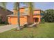 Two-story home with a two-car garage and landscaping in a well-maintained front yard at 2660 Santosh Cv, Kissimmee, FL 34746
