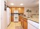 Well-lit kitchen with granite countertops, wood cabinets, and tile backsplash at 2660 Santosh Cv, Kissimmee, FL 34746