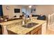 Open-concept kitchen with granite counters overlooking the living area at 2660 Santosh Cv, Kissimmee, FL 34746