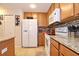 Bright kitchen with stainless appliances, granite countertops, and wooden cabinetry at 2660 Santosh Cv, Kissimmee, FL 34746
