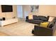 Comfortable living room with soft carpet, a large sectional, television, and bright natural light at 2660 Santosh Cv, Kissimmee, FL 34746
