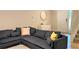 Inviting living room features a corner sectional, bright walls, and ample natural light at 2660 Santosh Cv, Kissimmee, FL 34746