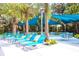 Resort-style pool area featuring lounge chairs and shaded seating, perfect for relaxation at 2660 Santosh Cv, Kissimmee, FL 34746