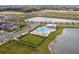 Community amenities include large pond and pool surrounded by manicured grounds and walkways at 2841 Willowseed Ln, St Cloud, FL 34772