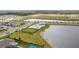 Community amenities include large pond and pool surrounded by manicured grounds and walkways at 2841 Willowseed Ln, St Cloud, FL 34772