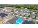 Aerial shot of the property in a residential neighborhood, surrounded by green lawns, streets, and neighboring houses at 2841 Willowseed Ln, St Cloud, FL 34772