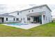 Relaxing backyard featuring a private pool, patio area with outdoor seating, and a well-maintained lawn at 2841 Willowseed Ln, St Cloud, FL 34772
