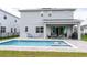 Beautiful backyard featuring a private pool, patio area with outdoor seating, and a well-maintained lawn at 2841 Willowseed Ln, St Cloud, FL 34772