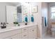 Bathroom featuring double sink vanity, light fixtures, and modern fixtures plus a view into the commode area at 2841 Willowseed Ln, St Cloud, FL 34772