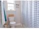 Bathroom featuring a toilet, tiled floors, towel rack and a shower with stylish striped shower curtain at 2841 Willowseed Ln, St Cloud, FL 34772