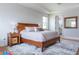 Spacious bedroom with a wooden bed frame, stylish nightstands, soft rug, and a serene ambiance at 2841 Willowseed Ln, St Cloud, FL 34772