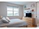 Serene bedroom with a large window, plush bed, and modern dresser for ample storage at 2841 Willowseed Ln, St Cloud, FL 34772