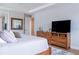 Comfortable bedroom featuring a wooden dresser with storage and a wall-mounted television creating a relaxing retreat at 2841 Willowseed Ln, St Cloud, FL 34772