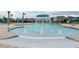 Gathering-friendly community pool with splash fountain and seating areas under blue umbrellas at 2841 Willowseed Ln, St Cloud, FL 34772
