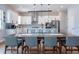 Modern kitchen and dining area featuring a central island, and stainless appliances at 2841 Willowseed Ln, St Cloud, FL 34772