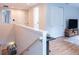 Bright hallway featuring wood floors, white trim, a desk area, and access to multiple rooms at 2841 Willowseed Ln, St Cloud, FL 34772