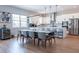 Bright kitchen and dining area featuring a large island, pendant lighting and stainless appliances at 2841 Willowseed Ln, St Cloud, FL 34772