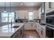 Modern kitchen with white cabinets, quartz countertops, stainless steel appliances and sleek finishes at 2841 Willowseed Ln, St Cloud, FL 34772
