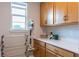 Well-organized laundry space with modern cabinets, counter space, drying rack and vacuum for easy cleaning at 2841 Willowseed Ln, St Cloud, FL 34772