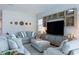 Bright living room with stylish sectional sofa, large TV, and decorative wall art at 2841 Willowseed Ln, St Cloud, FL 34772
