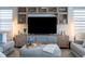 Comfortable living room features built-in shelving, modern decor, and an ottoman at 2841 Willowseed Ln, St Cloud, FL 34772