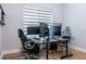 Spacious office featuring dual workstations, modern computer setups, and a large window for natural light at 2841 Willowseed Ln, St Cloud, FL 34772