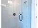 Walk-in shower with matte black hardware, sleek subway tile, and glass door offering a modern and luxurious feel at 2841 Willowseed Ln, St Cloud, FL 34772
