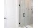 Modern bathroom with a glass-enclosed shower featuring sleek tile work, contrasting hardware, and a built-in bench at 2841 Willowseed Ln, St Cloud, FL 34772