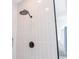 Modern shower featuring sleek gray vertical tile and a contemporary black shower head and faucet at 2841 Willowseed Ln, St Cloud, FL 34772