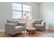 Cozy sitting area with two comfortable chairs, a colorful ottoman, and natural light streaming through the large window at 2841 Willowseed Ln, St Cloud, FL 34772