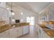 Kitchen with white appliances, granite countertops, tiled backsplash and an open transition to the living room at 2903 Joseph Cir, Oviedo, FL 32765