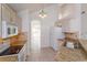 Bright kitchen with white appliances, granite countertops, and natural wood cabinets with tiled backsplash at 2903 Joseph Cir, Oviedo, FL 32765