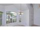 Sun-filled dining area with a hanging chandelier and large windows for lots of natural light at 2903 Joseph Cir, Oviedo, FL 32765