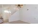 Open concept living area featuring a high ceiling, a staircase, and tile flooring at 2903 Joseph Cir, Oviedo, FL 32765