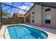 Relaxing pool area featuring a screened-in enclosure, with a tranquil backyard, and a glimpse of sunny skies at 2903 Joseph Cir, Oviedo, FL 32765