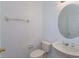 A half bathroom featuring neutral colors, toilet, pedestal sink, and an oval mirror at 2903 Joseph Cir, Oviedo, FL 32765