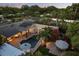 Aerial view of the backyard featuring a swimming pool, an outdoor kitchen, mature trees, and a spacious patio at 2918 Wessex St, Orlando, FL 32803