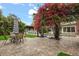 Landscaped backyard features a dining area, barbecue, a pool, and a beautiful flowering tree at 2918 Wessex St, Orlando, FL 32803