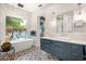 Luxurious bathroom with a freestanding tub, modern vanity, television, and patterned floor tiles at 2918 Wessex St, Orlando, FL 32803