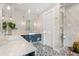 Bright bathroom featuring a double vanity, marble countertop, and stylish patterned floor tiles at 2918 Wessex St, Orlando, FL 32803