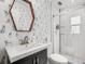 Stylish bathroom features dog-themed wallpaper, a hexagon mirror, a vanity, and a glass-enclosed shower at 2918 Wessex St, Orlando, FL 32803