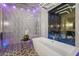 Modern bathroom with a freestanding tub and large window overlooking lush landscaping and a shower at 2918 Wessex St, Orlando, FL 32803