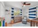 Bright Bedroom featuring hardwood floors, a ceiling fan, a dresser, and a cozy chair with a matching ottoman at 2918 Wessex St, Orlando, FL 32803