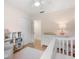 Bright Bedroom features a white crib, changing table, and closet, offering a serene space at 2918 Wessex St, Orlando, FL 32803