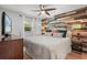 Cozy bedroom with a decorative wood accent wall and a ceiling fan at 2918 Wessex St, Orlando, FL 32803