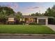 Charming single-story home with a well-manicured lawn, beautiful landscaping, and a cozy front porch at 2918 Wessex St, Orlando, FL 32803
