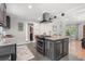Stylish kitchen island featuring granite countertops, stainless steel vent hood and views to the dining area at 2918 Wessex St, Orlando, FL 32803