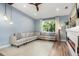 Comfortable living room with a large sectional sofa, a bright window, and a cozy fireplace, perfect for relaxation at 2918 Wessex St, Orlando, FL 32803